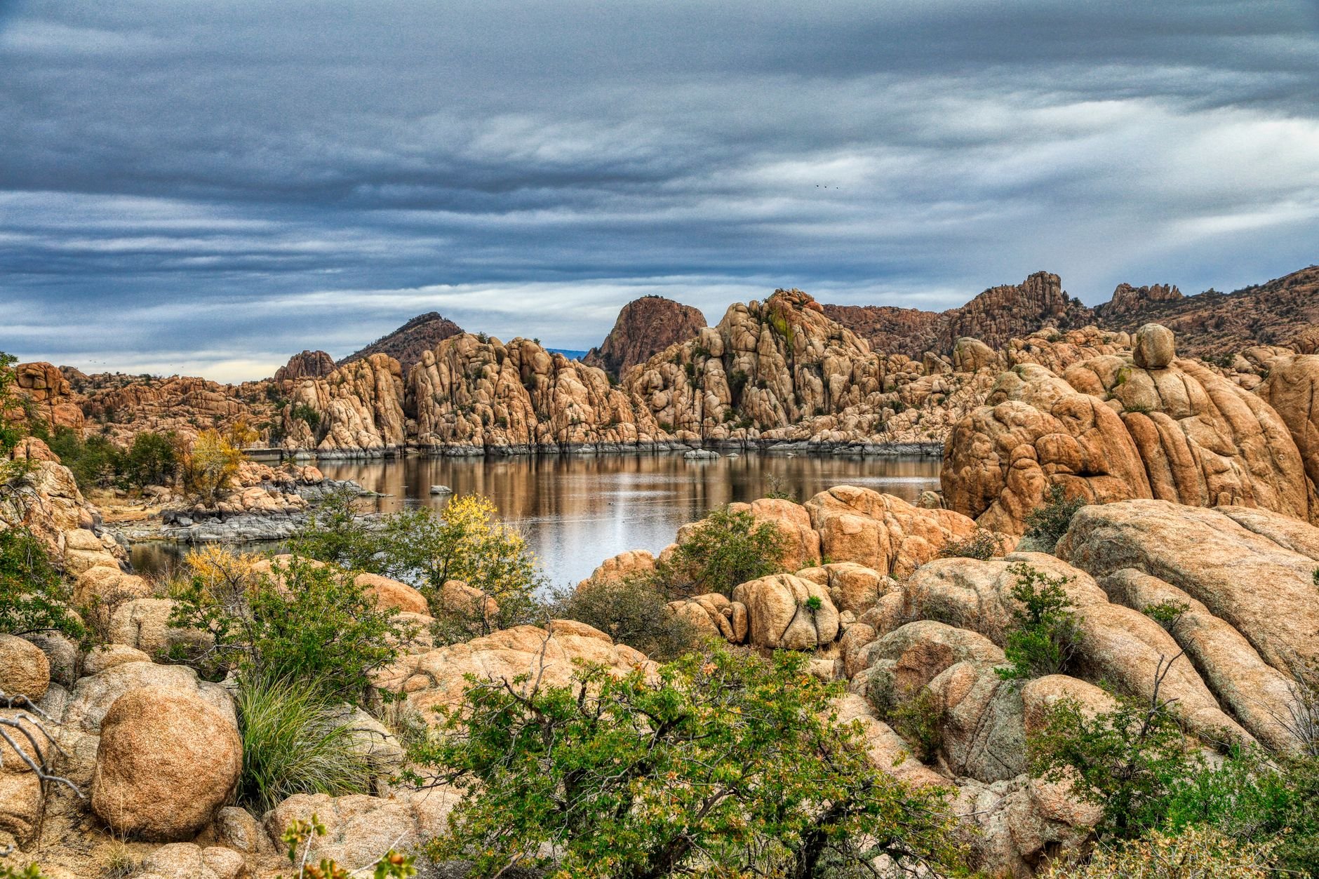Dramatic granite rock formations at the Granite Dells in Prescott, Arizona, reflected in still water